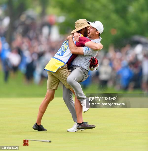 Nick Taylor of Canada celebrates with his caddie Dave Markle after sinking a 72-foot eagle putt to win the 2023 RBC Canadian Open at Oakdale Golf &...