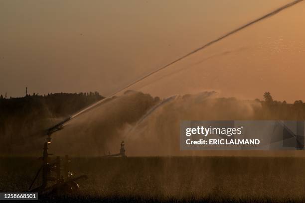 Aerial drone picture shows the watering of a field in Hellecine, at sunset, Tuesday 13 June 2023. BELGA PHOTO ERIC LALMAND