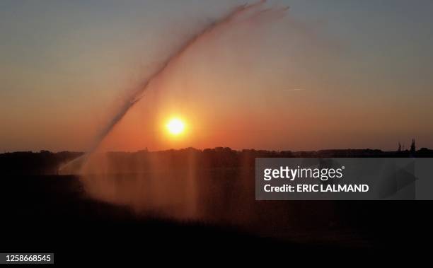 Aerial drone picture shows the watering of a field in Hellecine at sunset, Tuesday 13 June 2023. BELGA PHOTO ERIC LALMAND