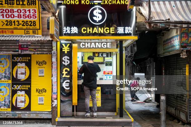 Customer is seen at a currency exchange and money change company shop in Hong Kong.