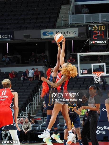 Aliyah Boston of the Indiana Fever and Shakira Austin of the Washington Mystics reach for the tip off during the game on June 13, 2023 at Gainbridge...