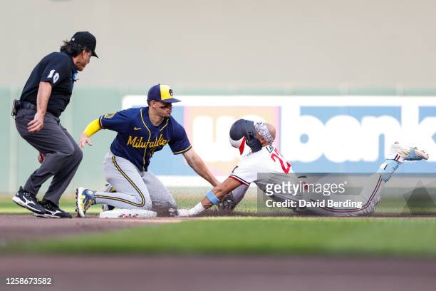 Royce Lewis of the Minnesota Twins is tagged out at second base trying to stretch his single by Willy Adames of the Milwaukee Brewers in the second...