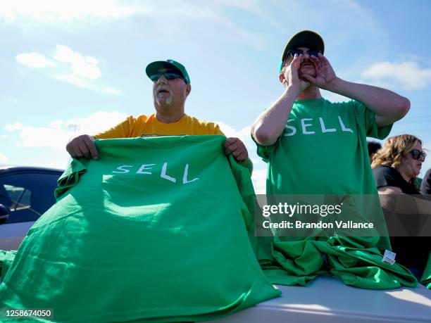 Oakland Athletics fans are handed out free t-shirt shirts labeled 'SELL' prior to a reverse boycott game against the Tampa Bay Rays at RingCentral...