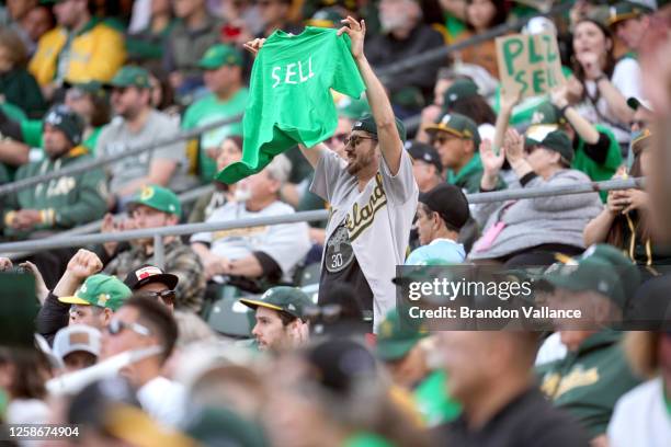 Oakland Athletics fans display signs during a reverse boycott game against the Tampa Bay Rays at RingCentral Coliseum on June 13, 2023 in Oakland,...