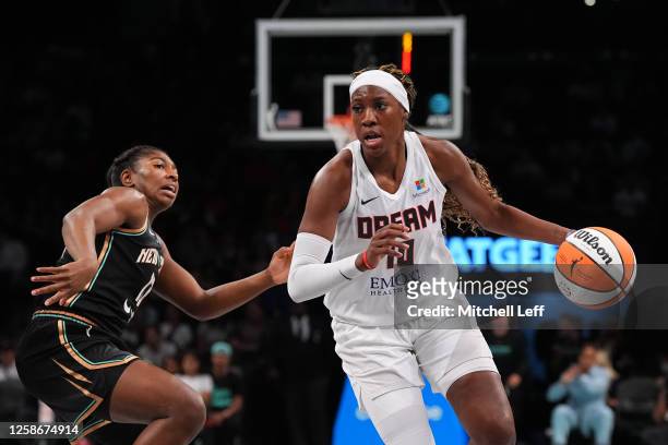 Rhyne Howard of the Atlanta Dream drives against Jocelyn Willoughby of the New York Liberty in the second half at the Barclays Center on June 13,...