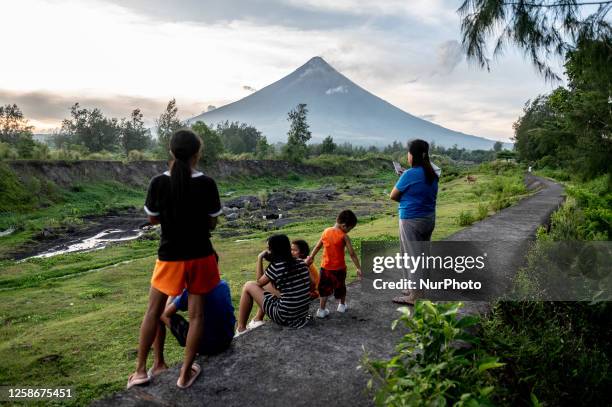 People look at the Mayon Volcano which remains under alert level 3, in Legazpi, Albay province, Philippines, on June 13, 2023.