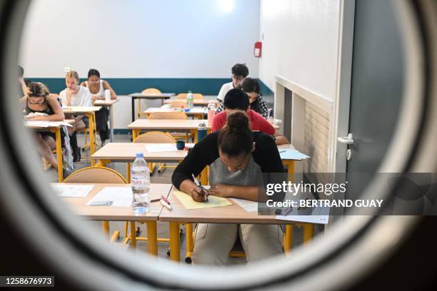 Pupils take the philosophy test as part of the baccalaureat exams, at the Academie de Paris, in Paris, on June 14, 2023.