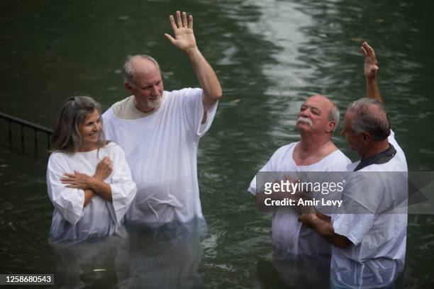 Christian pilgrims bath in the Jordan River near the northern Israeli city of Tiberias on June 13, 2023 in Tiberias, Israel.