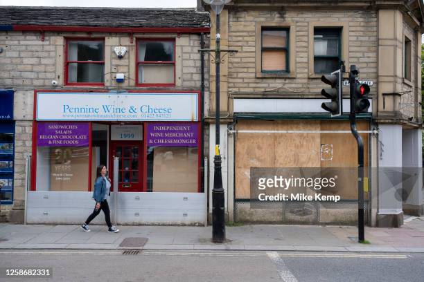 Flood defences outside small businesses which are closed down and boarded up on 7th June 2023 in Hebden Bridge, United Kingdom. Hebden Bridge is a...