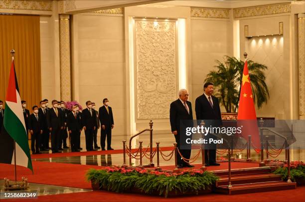 China's President Xi Jinping and Palestinian President Mahmud Abbas attend a welcoming ceremony at the Great Hall of the People in Beijing on June...