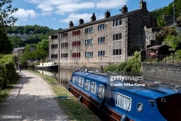 Scene of old industrial mill buildings along the Rochdale Canal on 7th June 2023 in Hebden Bridge, United Kingdom. In the 19th and 20th centuries the...