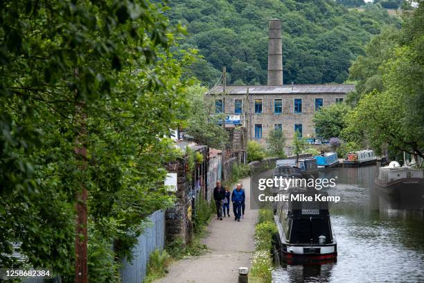 Scene of old industrial mill buildings along the Rochdale Canal on 7th June 2023 in Hebden Bridge, United Kingdom. In the 19th and 20th centuries the...