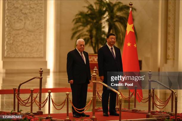 China's President Xi Jinping and Palestinian President Mahmud Abbas attend a welcoming ceremony at the Great Hall of the People in Beijing on June...