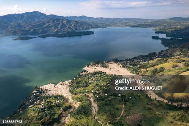 This aerial photograph taken on June 9, 2023 shows the partially destroyed village of Bushushu on the shores of Lake Kivu in Kalehe Territory, South...