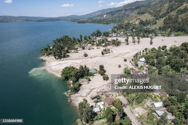 This aerial photograph taken on June 9, 2023 shows the partially destroyed village of Bushushu on the shores of Lake Kivu in Kalehe Territory, South...