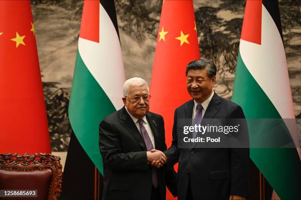 Palestinian President Mahmud Abbas shakes hands with China’s President Xi Jinping after a signing ceremony at the Great Hall of the People in Beijing...
