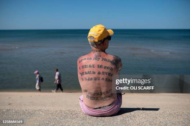 People enjoy the sunshine on the beach in Blackpool, north west England on June 14, 2023