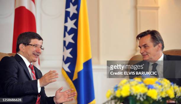 Turkish Foreign Affairs minister Ahmet Davutoglu confers with member of Bosnia's tripartite Presidency, Haris Silajdzic in Sarajevo, on October 16,...