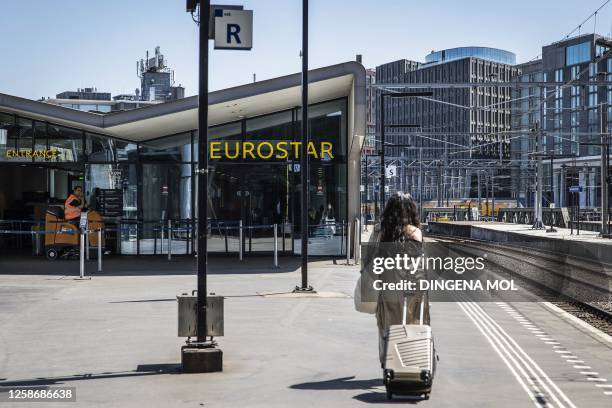 Woman walks in front of the Eurostar Terminal at Amsterdam Central Station, on June 14, 2023. In 2024, there will be no trains between Amsterdam and...