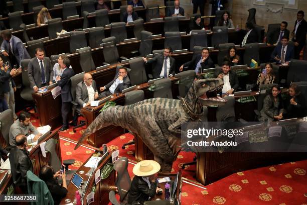 Frankie the dinosaur, a character from the United Nations Development Program arrives at the Colombian Congress, accompanied by the Minister of...