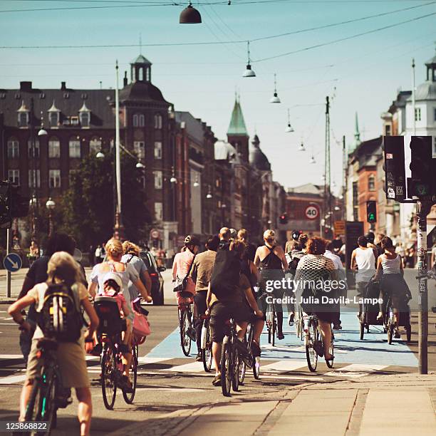 bicyle riders on street in copenhagen - copenhagen fotografías e imágenes de stock