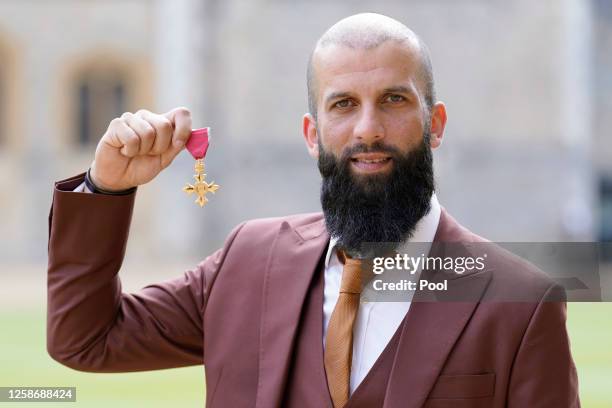 Moeen Ali poses after being made an Officer of the Order of the British Empire by the Princess Royal during an investiture ceremony at Windsor Castle...