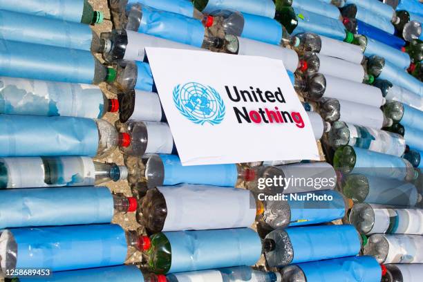Ukraine activists install a hundred of water bottles with a sign of '' United Nothing'' at square of United Nation in Bonn, Germany on June 14, 2023...