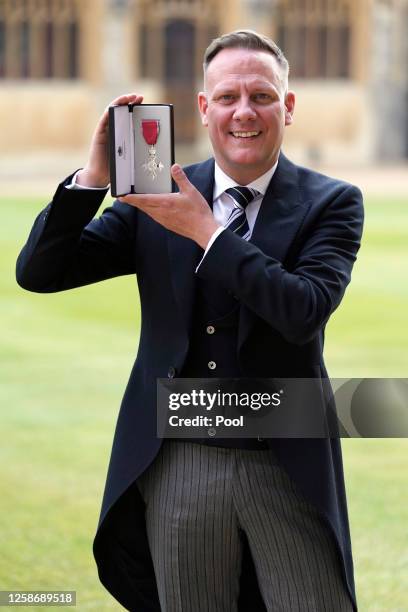 Antony Cotton poses after being made a Member of the Order of the British Empire by the Princess Royal during an investiture ceremony at Windsor...