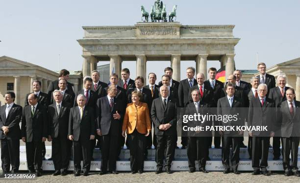 The heads of state of the 27 European Union nations pose for a family photo around German Chancellor Angela Merkel , whose country currently holds...