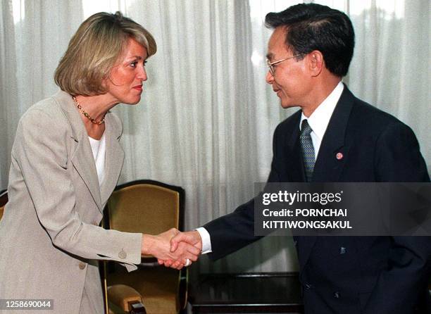 Colombian Foreign Minister Maria Emma Mejia Velez shakes hands with Thai Prime Minister Chuan Leekpai 21 January during a courtesy call in Bangkok....