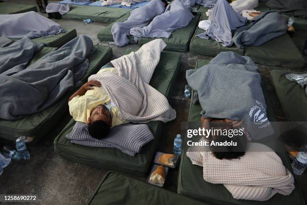 Rescued migrants find shelter at a depot, following a shipwreck off shore in Kalamata , Greece on June 14, 2023