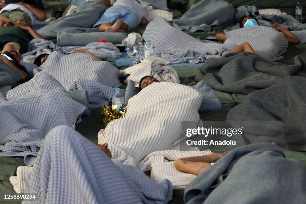 Rescued migrants find shelter at a depot, following a shipwreck off shore in Kalamata , Greece on June 14, 2023