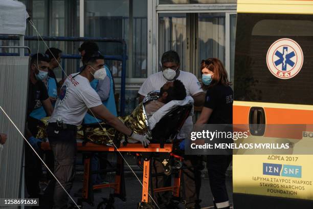 Migrant is transferred by rescuers, after a boat carrying dozens of migrants sank in the Ionian Sea, in Kalamata town, Greece, on June 14, 2023. At...