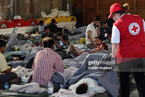 Rescued migrants find shelter at a depot, following a shipwreck offshore in Kalamata , Greece on June 14, 2023. At least 78 migrants drowned off...