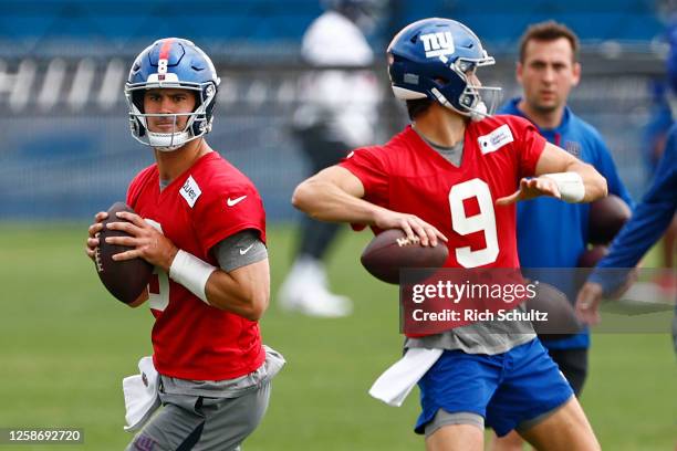 Quarterbacks Daniel Jones and Jacob Eason of the New York Giants look to pass during the team's mini camp at Quest Training Center on June 14, 2023...