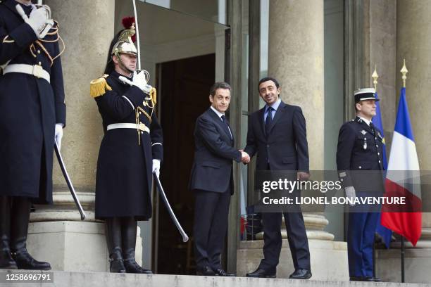 France's President Nicolas Sarkozy shakes hand with UAE Foreign Minister Sheikh Abdullah bin Zayed al-Nahyan as he arrives on March 19 at the Elysee...