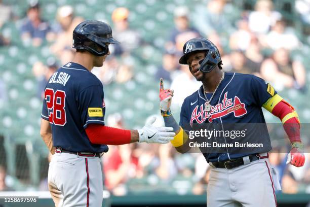 Ronald Acuna Jr. #13 of the Atlanta Braves celebrates with Matt Olson after hitting a solo home run against the Detroit Tigers during the third...