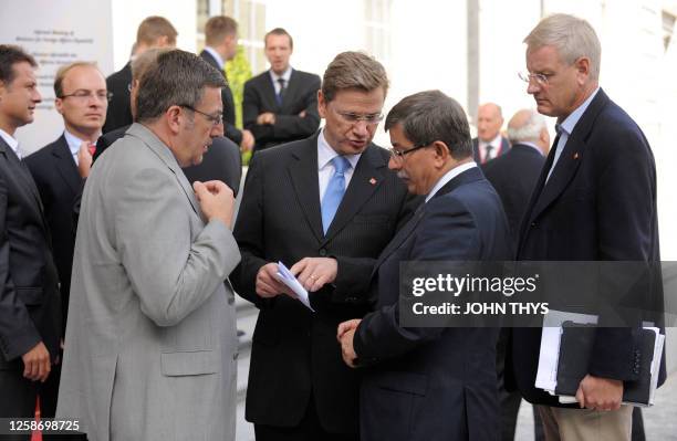 Turkish Foreign Affairs Minister Ahmet Davutoglu speaks with German Foreign Minister Guido Westerwelle with Belgian Foreign Minister Steven Vanackere...