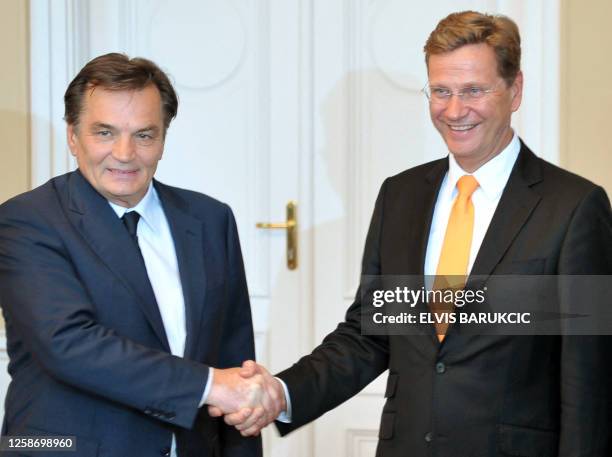 German Foreign Minister, Guido Westerwelle and Chairman of Bosnia's tripartite presidency, Haris Silajdzic shake hands before a meeting in Sarajevo...