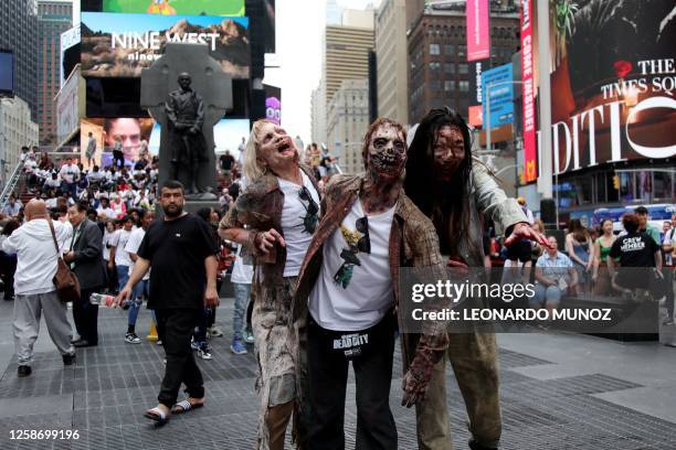 People participate in a zombie walk promoting the release of TV show "The Walking Dead: Dead City" in Times Square, New York, June 14, 2023.