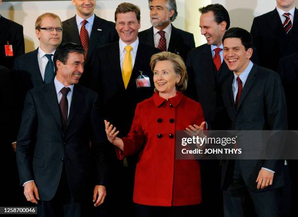 Secretary of State Hillary Clinton speaks with NATO Secretary General Anders Fogh Rasmussen and Britain's foreign secretary David Miliband , German...