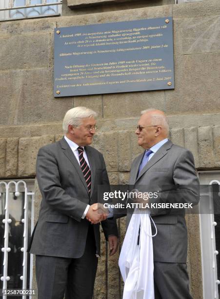 German Foreign Minister Frank-Walter Steinmeier and his Hungarian counterpart Peter Balazs stand by a commemorative plaque for the 20th anniversary...