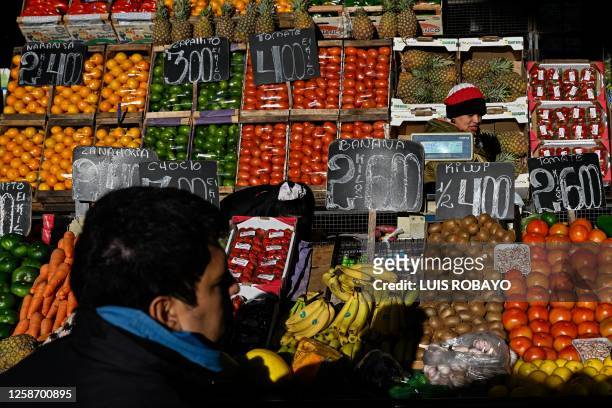People buy fruits and vegetables in the Central Market in Buenos Aires on June 13, 2023. Consumer price inflation in Argentina jumped 7.8 percent in...