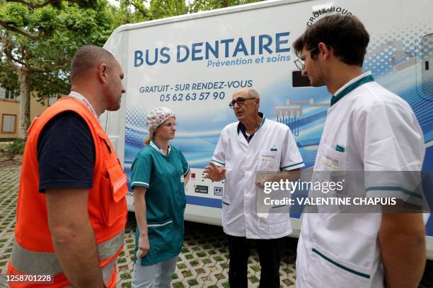 Doctor Daher speaks with final-year dentistry students Luna Desnot and Maxime Bellocq , and Sebastien Delmotte , coordinator of the Red Cross dental...
