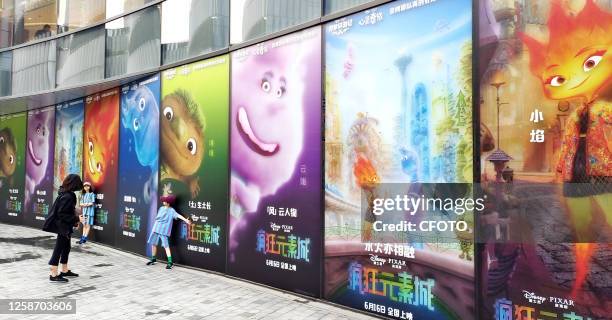 Parents take their children to watch the summer blockbuster "Elemental" released by China Film and produced by Disney Pixar Animation Studios at...