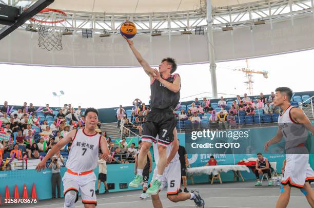 Players compete at a basketball court in Deqing Geographic Information town in Huzhou city, East China's Zhejiang province, June 15, 2023. On June 15...