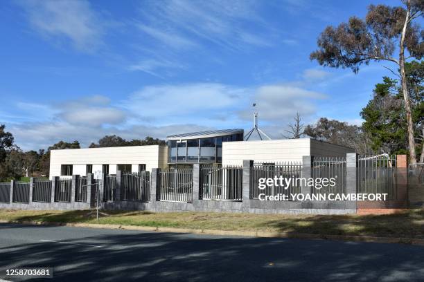 The Australian flag is seen on the Parliament House building behind an under construction structure on the grounds of a proposed new Russian embassy...