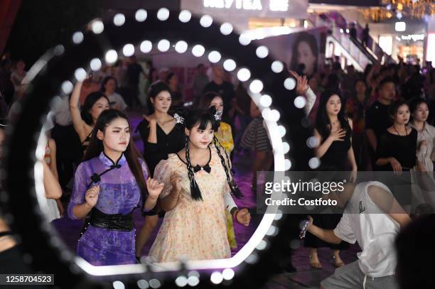 Fitness enthusiasts perform a square dance in Guiyang, Guizhou province, China, June 14, 2023.