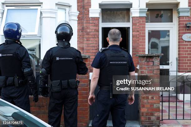 Immigration enforcement officers take part in a raid attended by Britain's prime minister in northwest London on June 15, 2023.