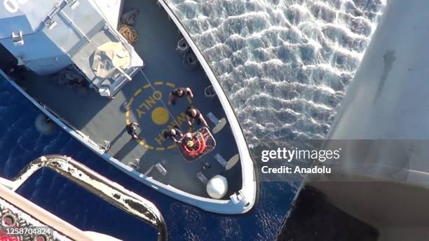 Screen grab captured from a video shows Greek teams carrying out search and rescue operation after a fishing boat crammed with migrants off the coast...